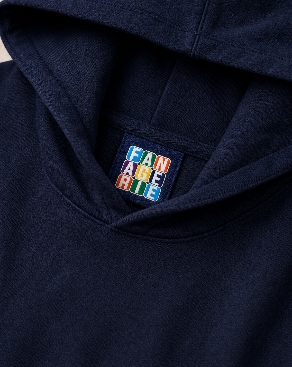 Close-up of the neck label and fabric on Fanagerie Serve and Win Stadium OS Hoodie
